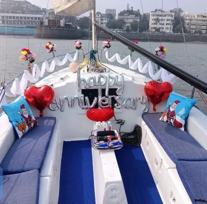 A happy anniversary balloon display on the bow with festive cushions
