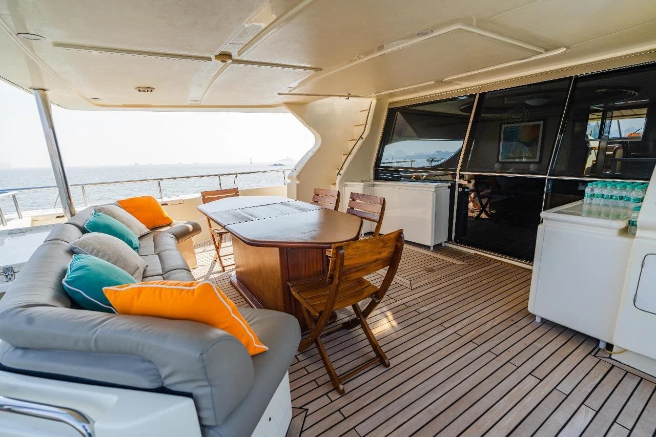 A second view of the aft deck's alfresco dining table and canopy