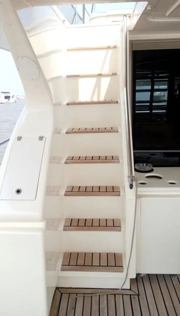 The teak-stepped staircase from the flybridge down to the cockpit