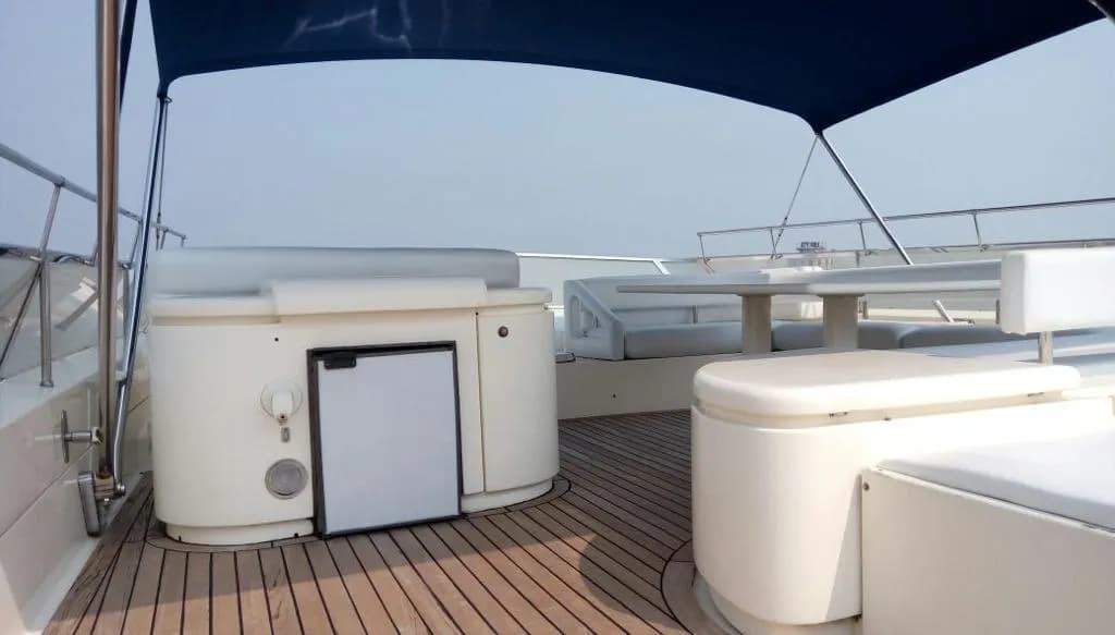 Flybridge seating beside the built-in wet bar and fridge unit