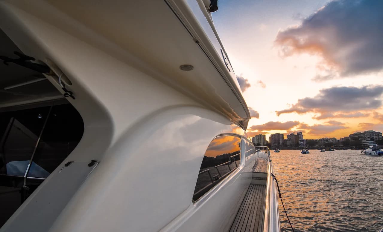 A second close-up of Allegra's hull and side deck at sunset
