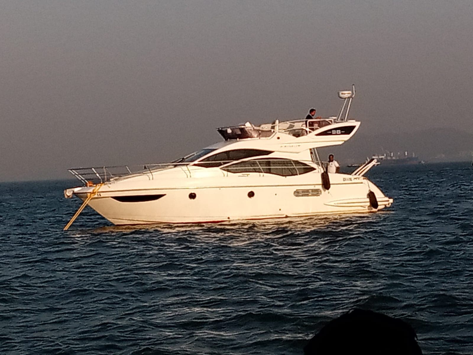 The Azimut 38 motor yacht at anchor off Mumbai at golden hour