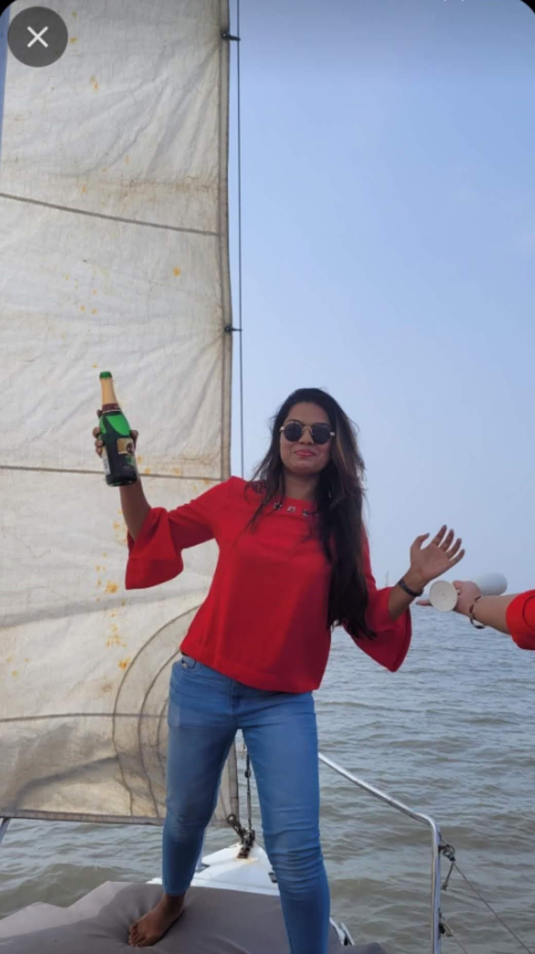 A guest raising a toast on deck during a bachelorette charter