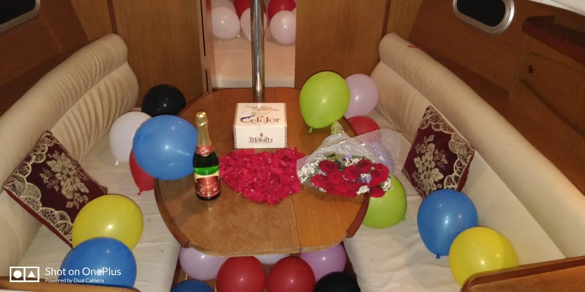 A rose bouquet and champagne set out on the saloon table for a proposal