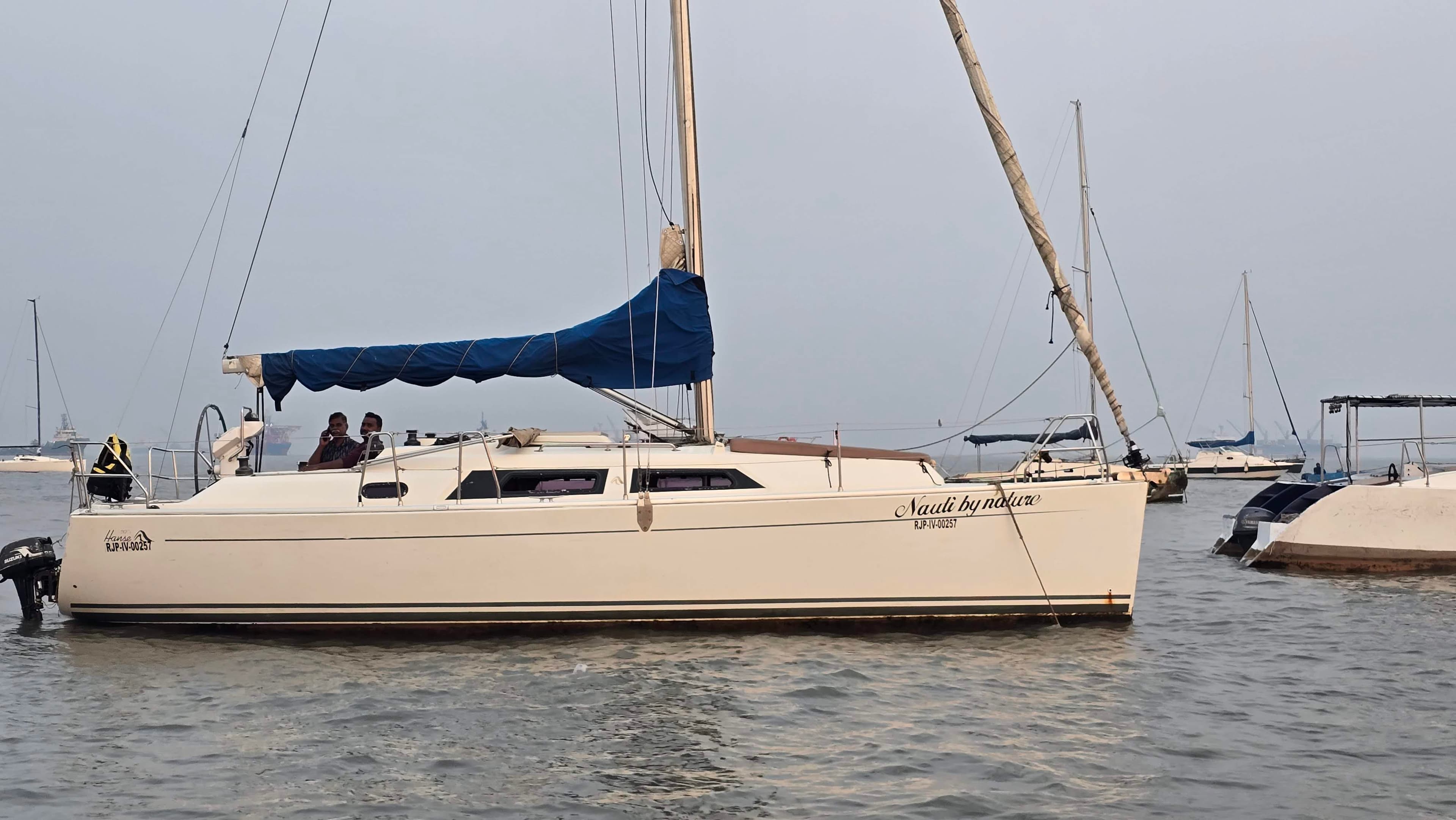 The Hanse 33's side profile at anchor with guests aboard