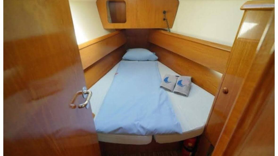 The forward cabin with a made-up berth and towels