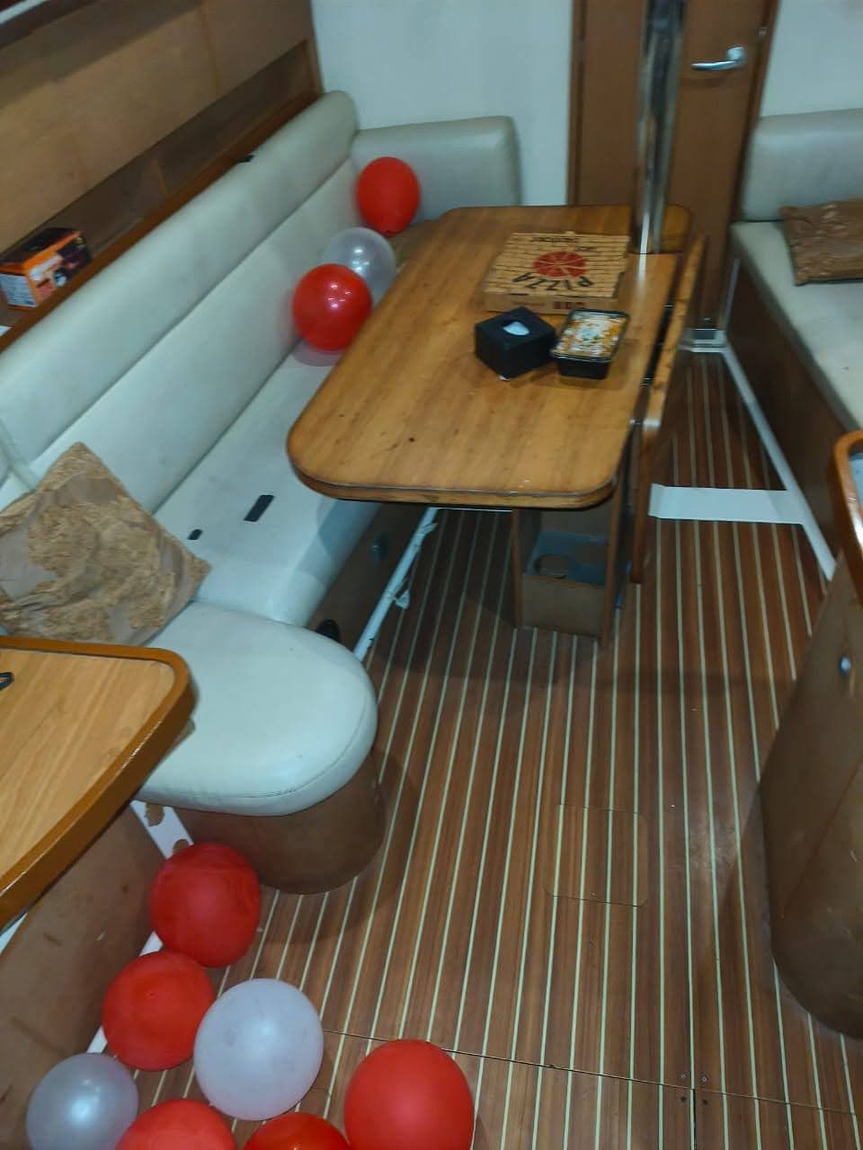 Pizza and snacks laid out on the saloon table decorated with balloons