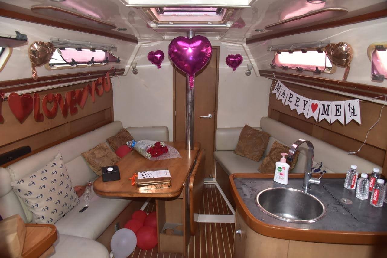A Marry Me proposal set-up in the saloon with heart balloons and roses