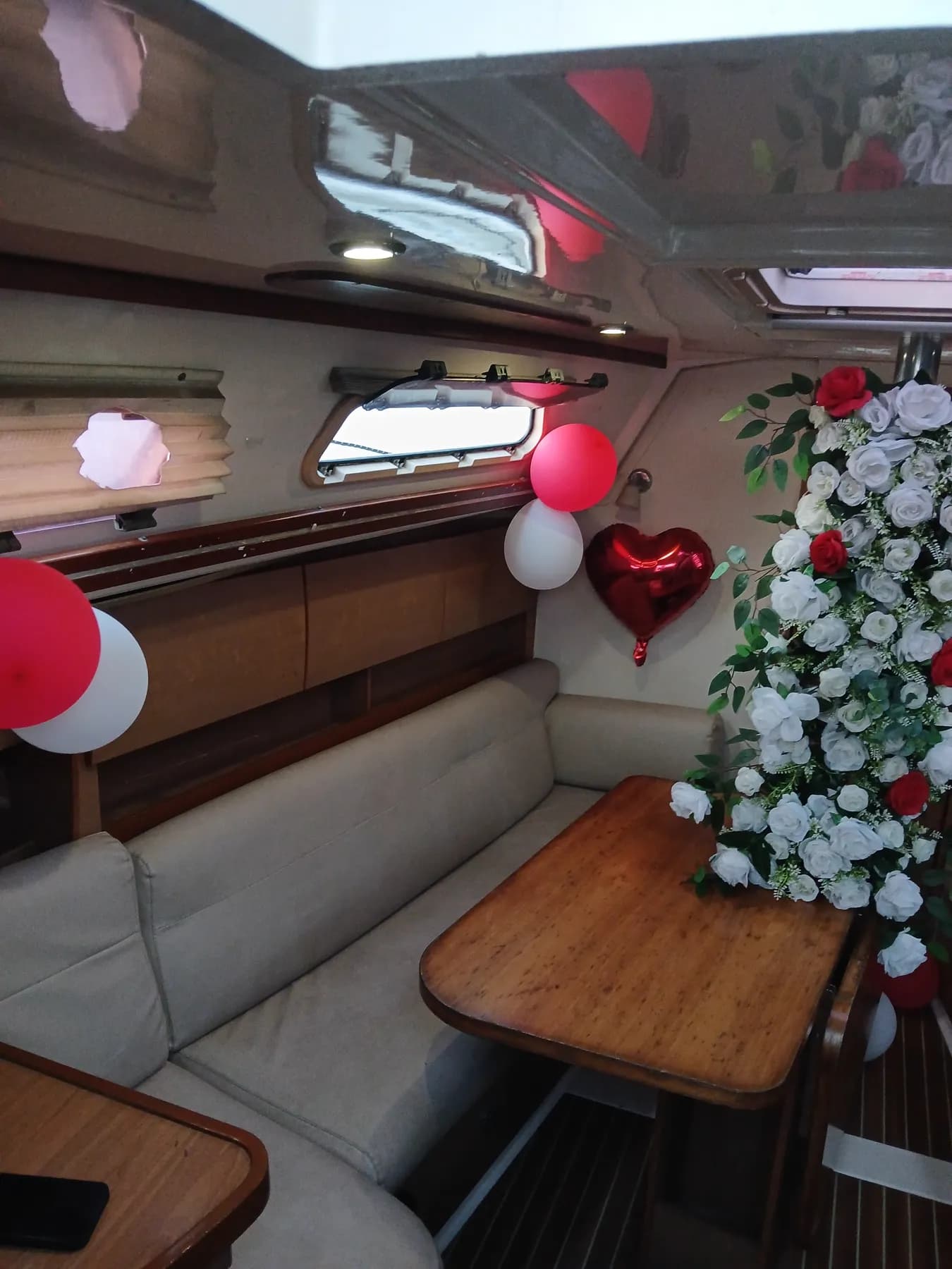 A close view of the saloon's rose garland and heart balloon proposal decor