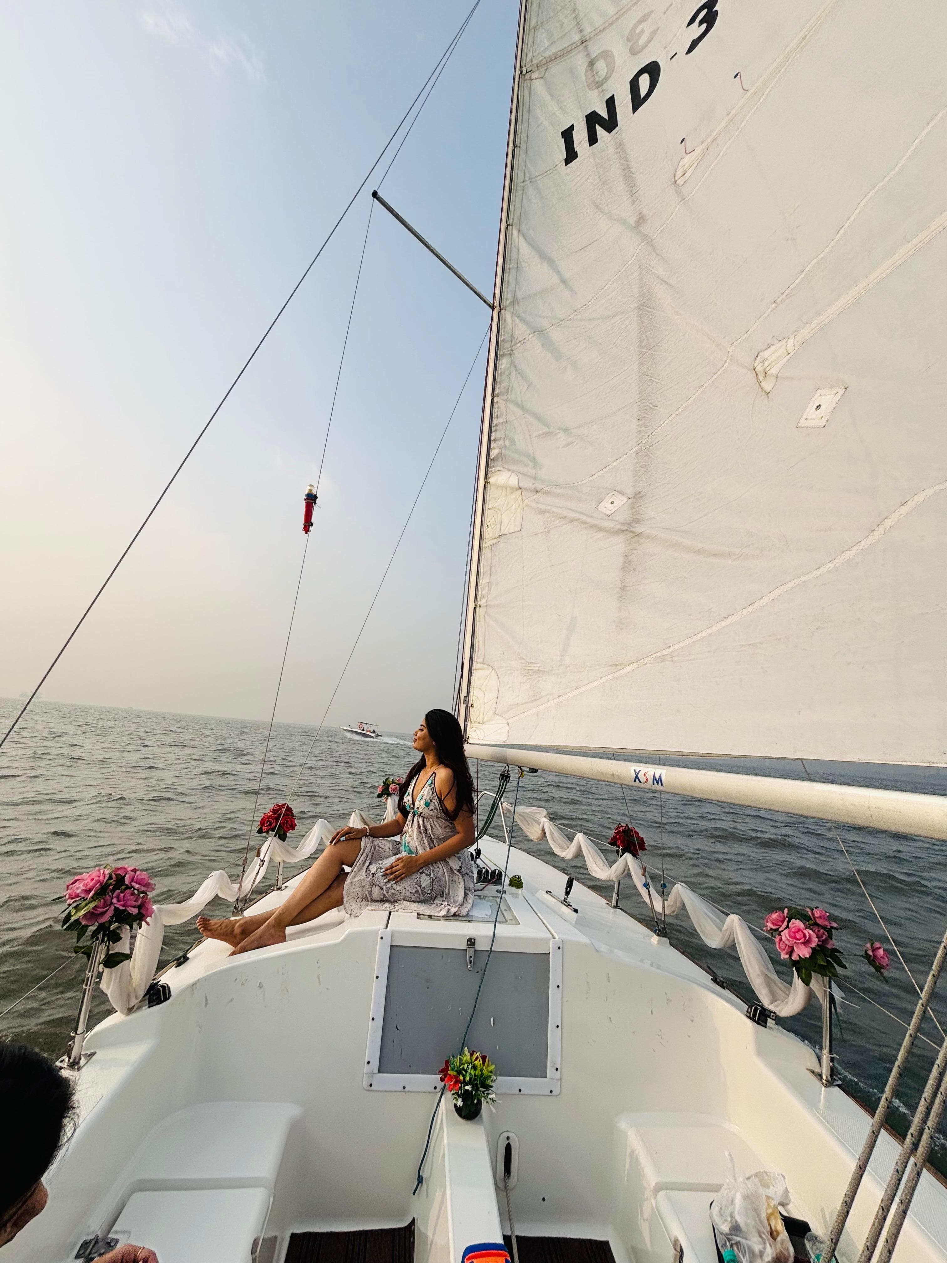 A guest seated at the flower-decorated bow under sail