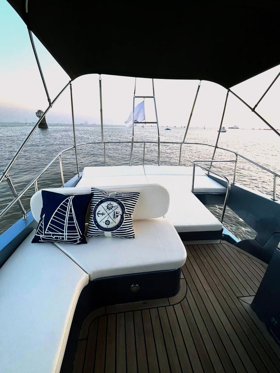 The foredeck lounge at sunset with the harbour behind