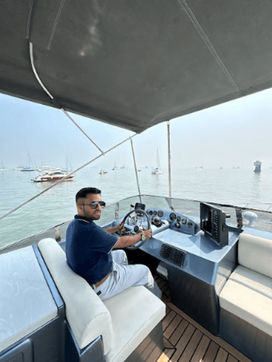 The captain at the helm with the harbour behind