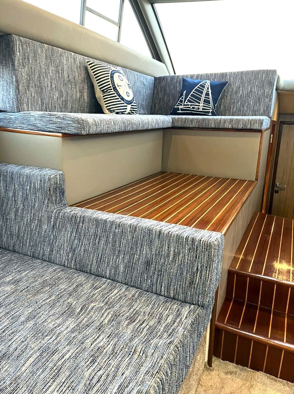 The lower saloon seating and teak steps down from the foredeck