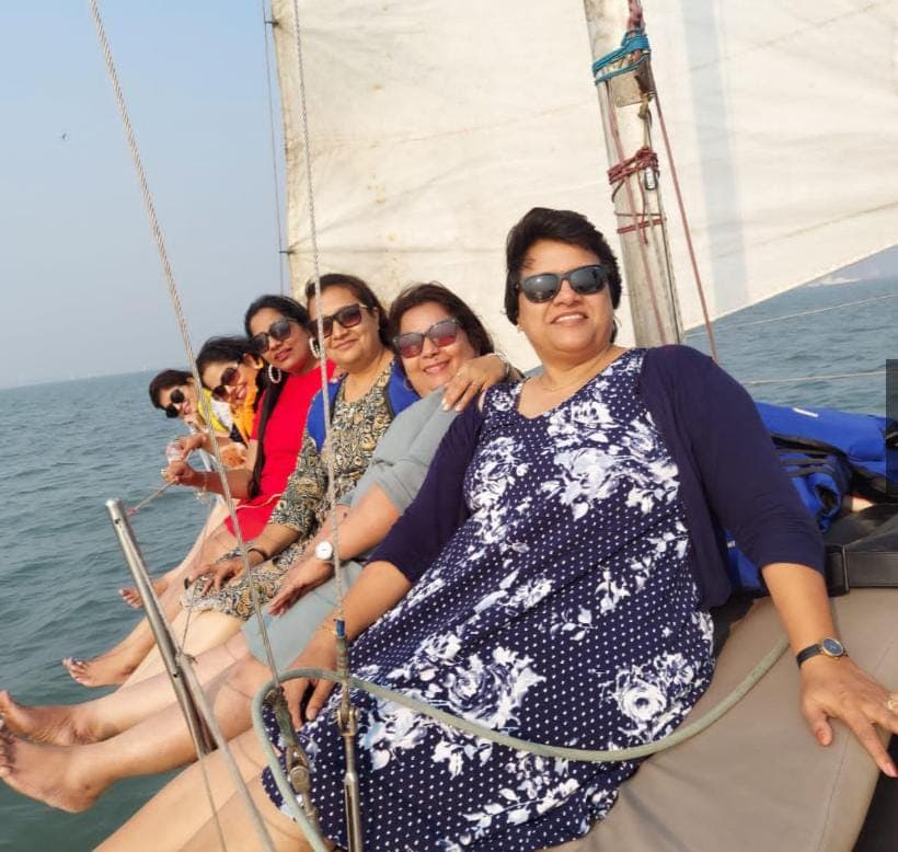 A group of women seated at the bow during a sunset sail