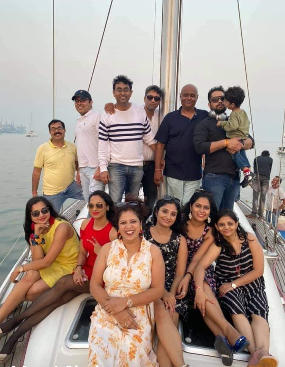 A large group of guests posed together on deck