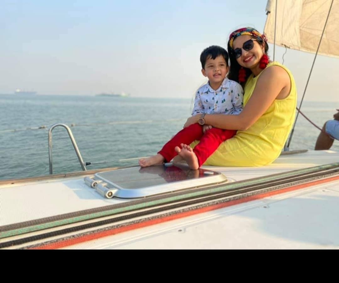 A mother and young child seated at the bow at sunset