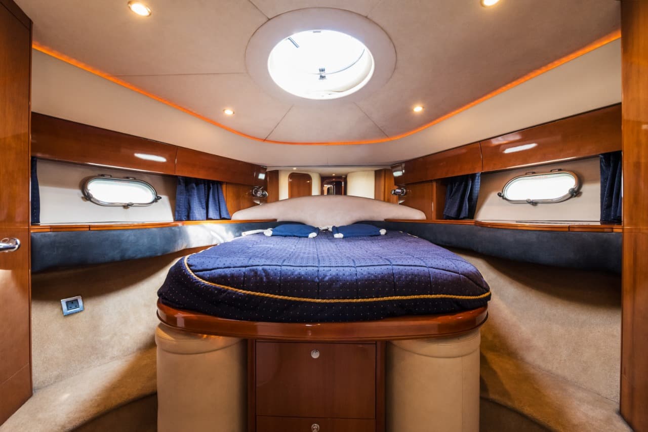 Forward guest cabin on the Princess 61 with double berth and overhead hatch