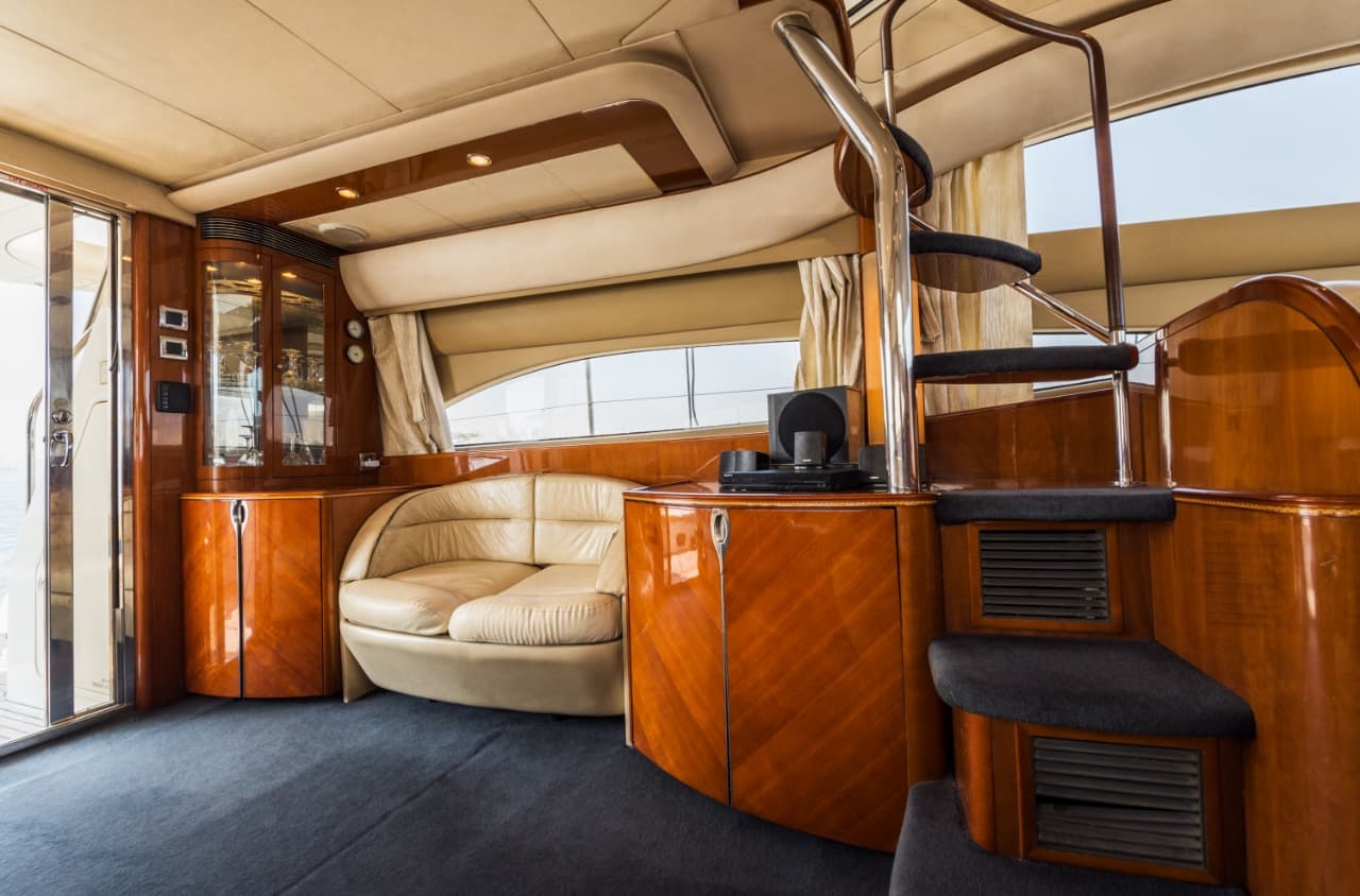 Saloon lounge area on the Princess 61 with bar cabinet and stairway to the flybridge