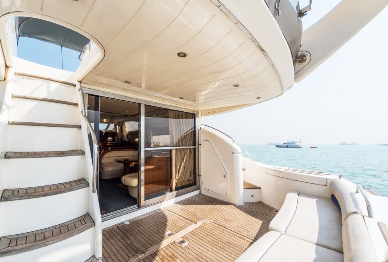 Teak-laid aft cockpit of the Princess 61 with seating and steps to the flybridge