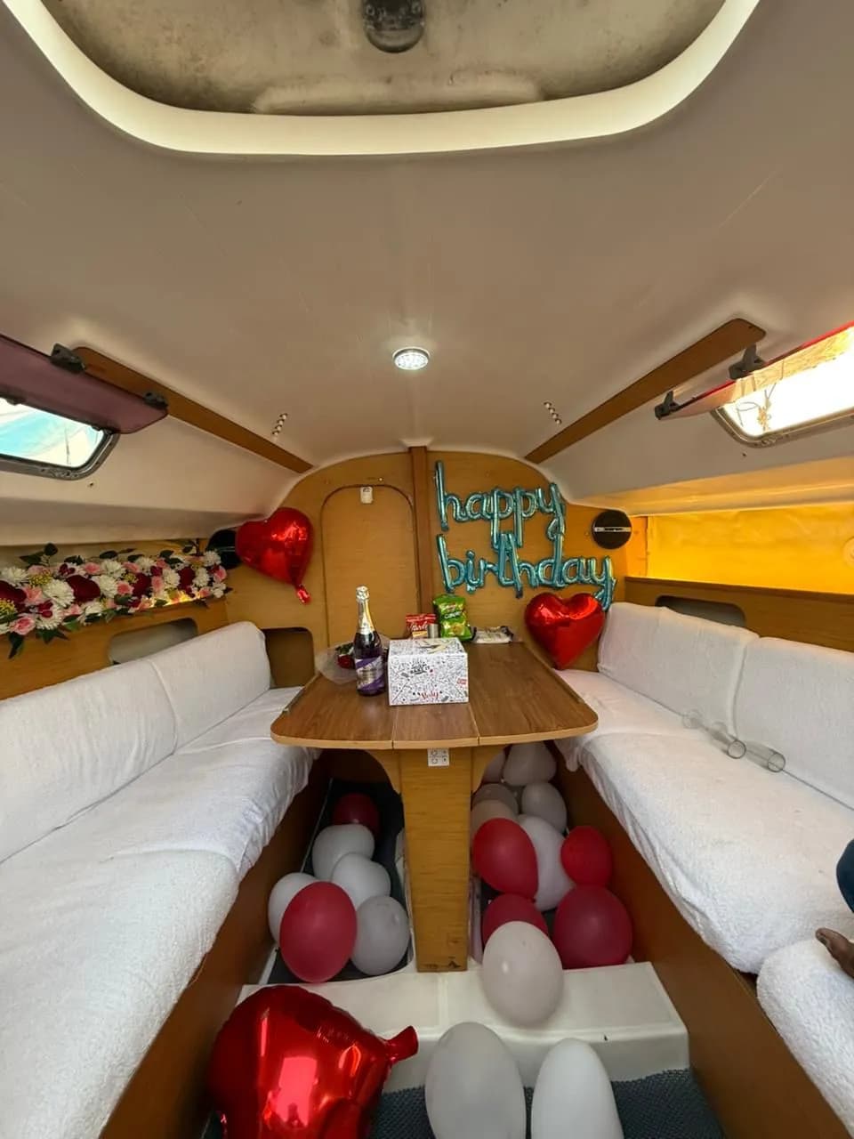A happy birthday balloon display in the below-deck cabin