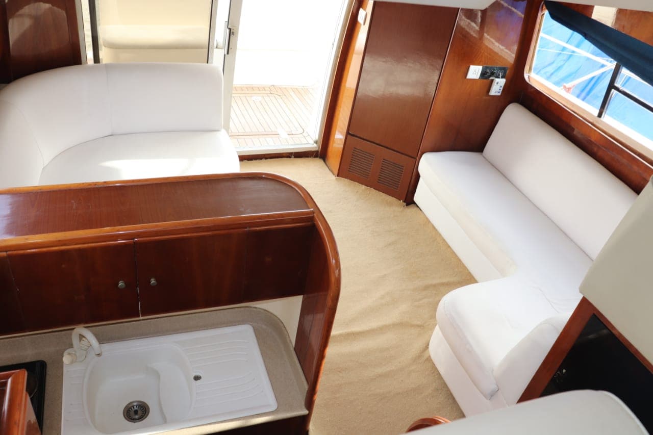 The teak-finished saloon and galley with wraparound seating