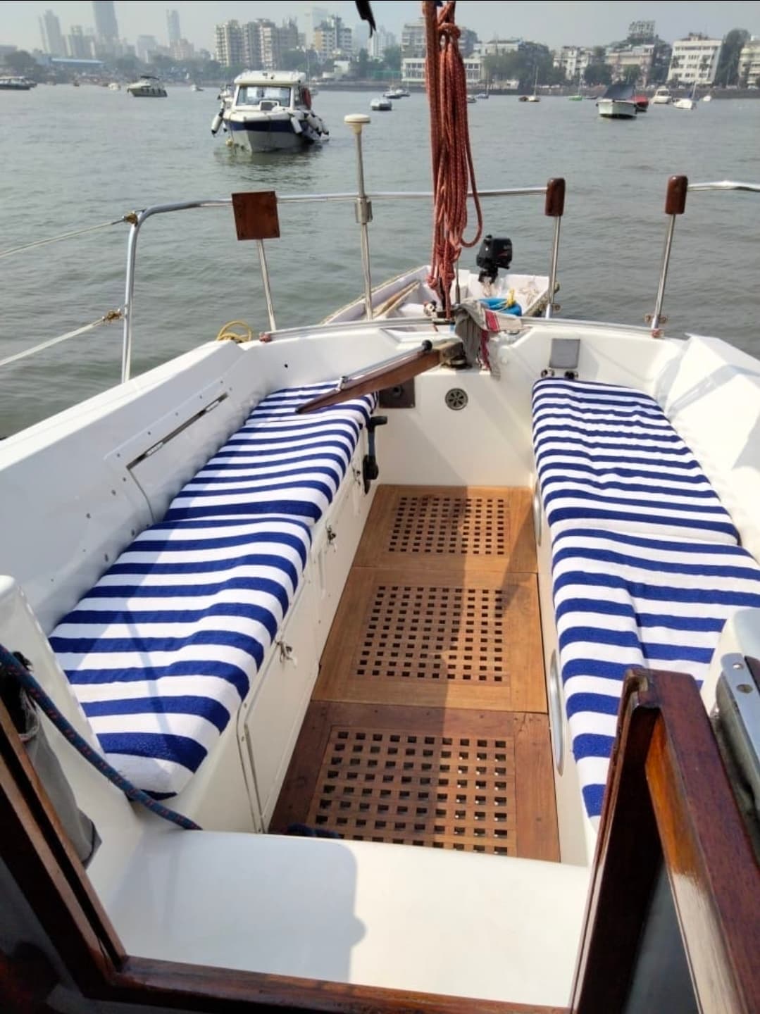 The cockpit's striped cushioned seating and teak fittings at anchor
