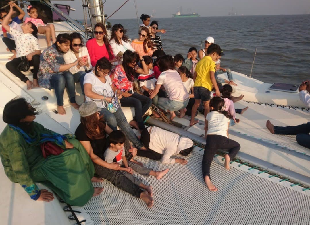 A family with children relaxing on Tara's forward trampoline netting