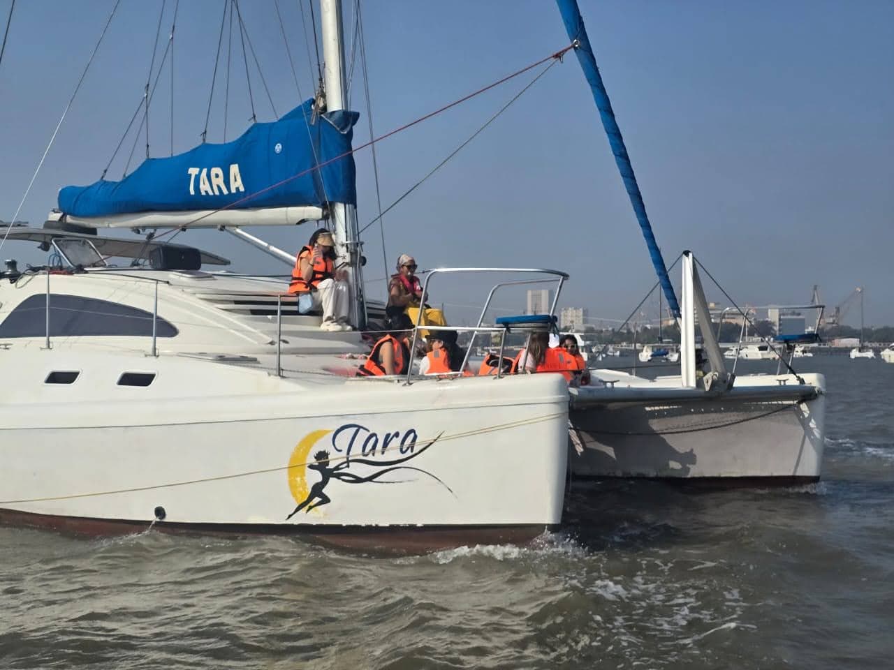 Tara's stern nameplate and logo with guests aboard the aft deck