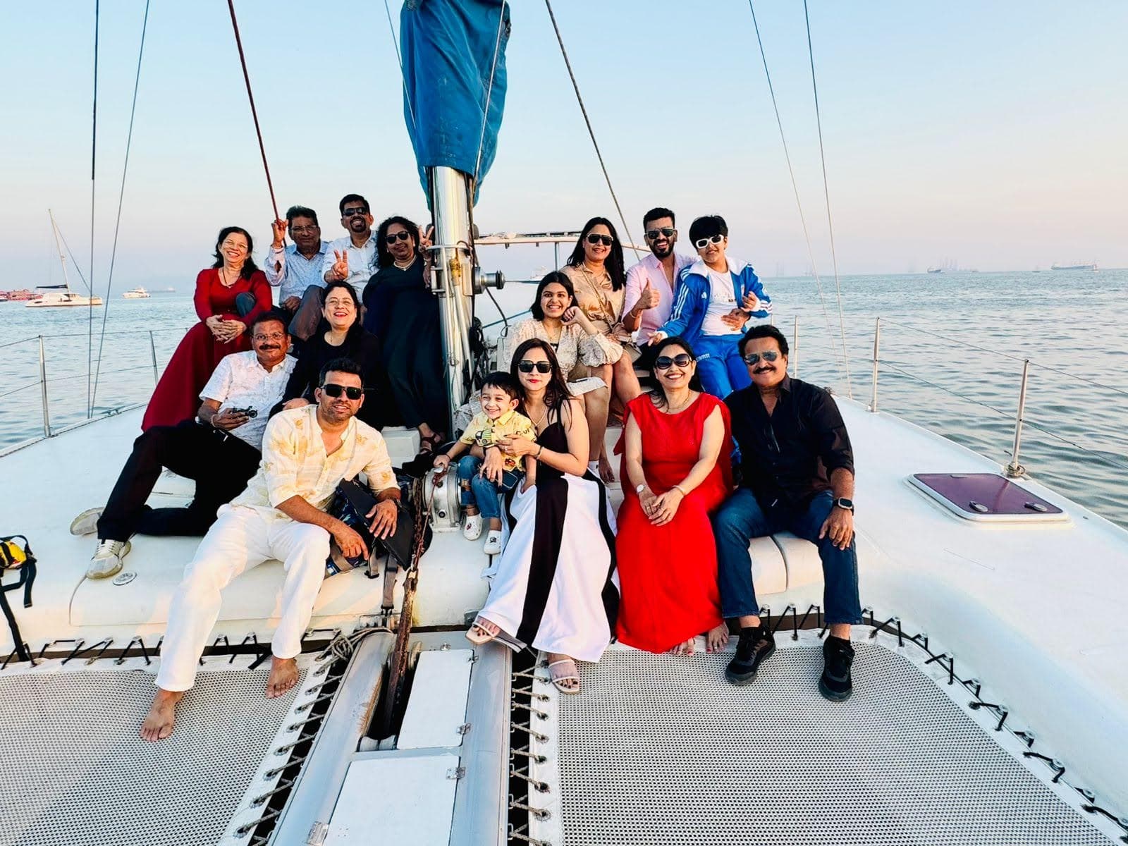 A formal group portrait on Tara's foredeck at golden hour