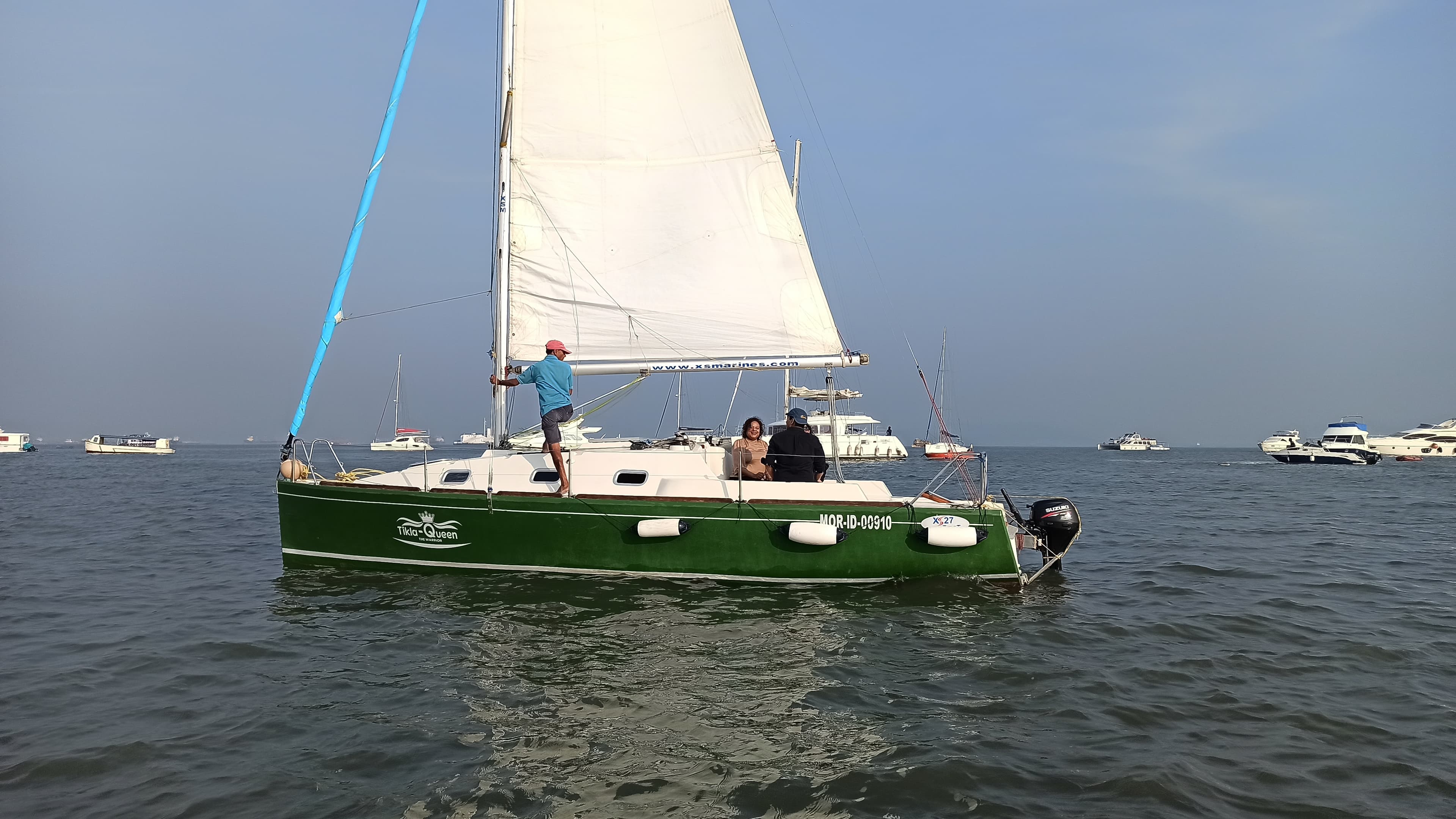The skipper and a small group of guests aboard Tikla Queen under sail