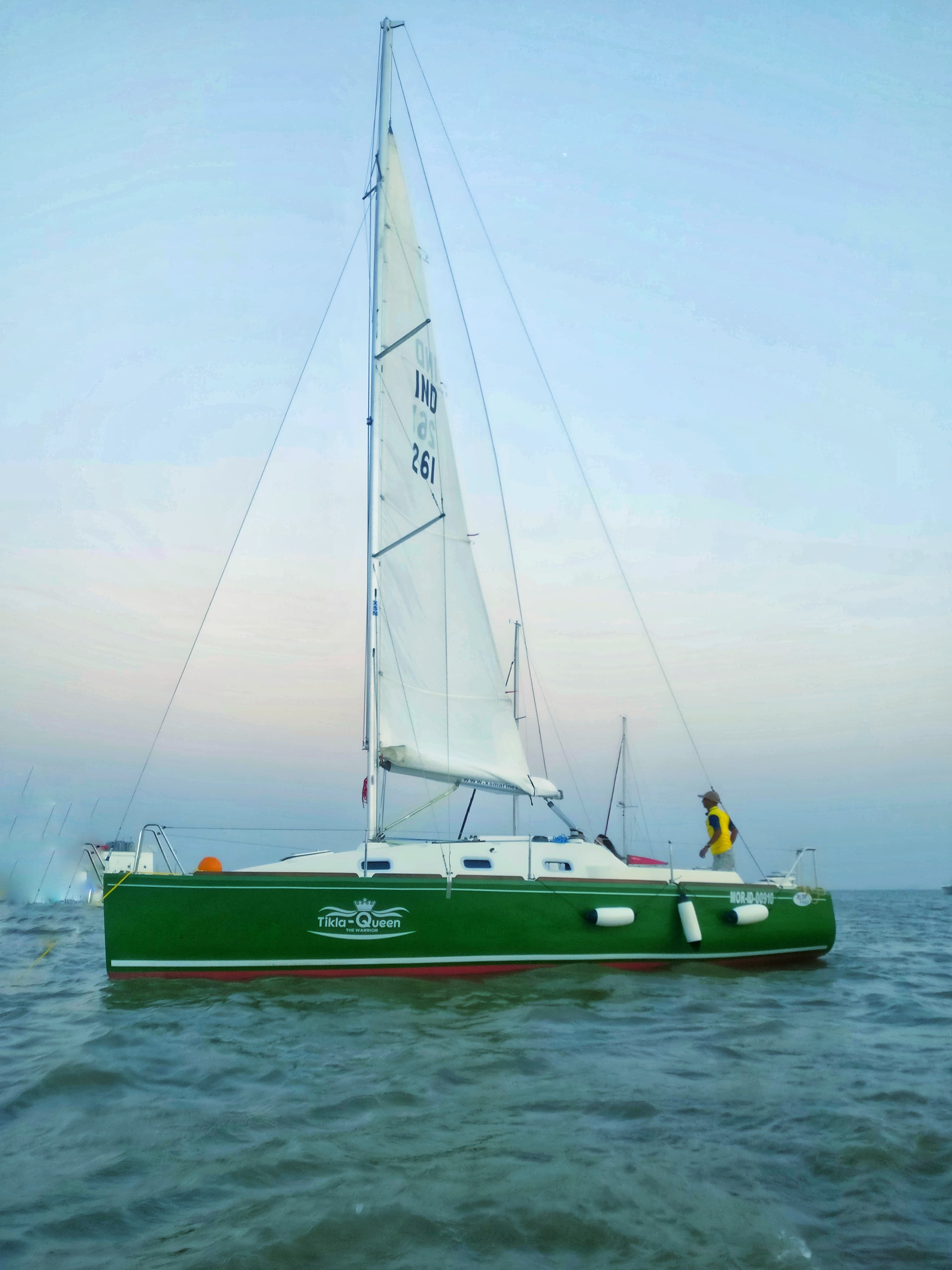 Tikla Queen's green hull and nameplate viewed from alongside at anchor