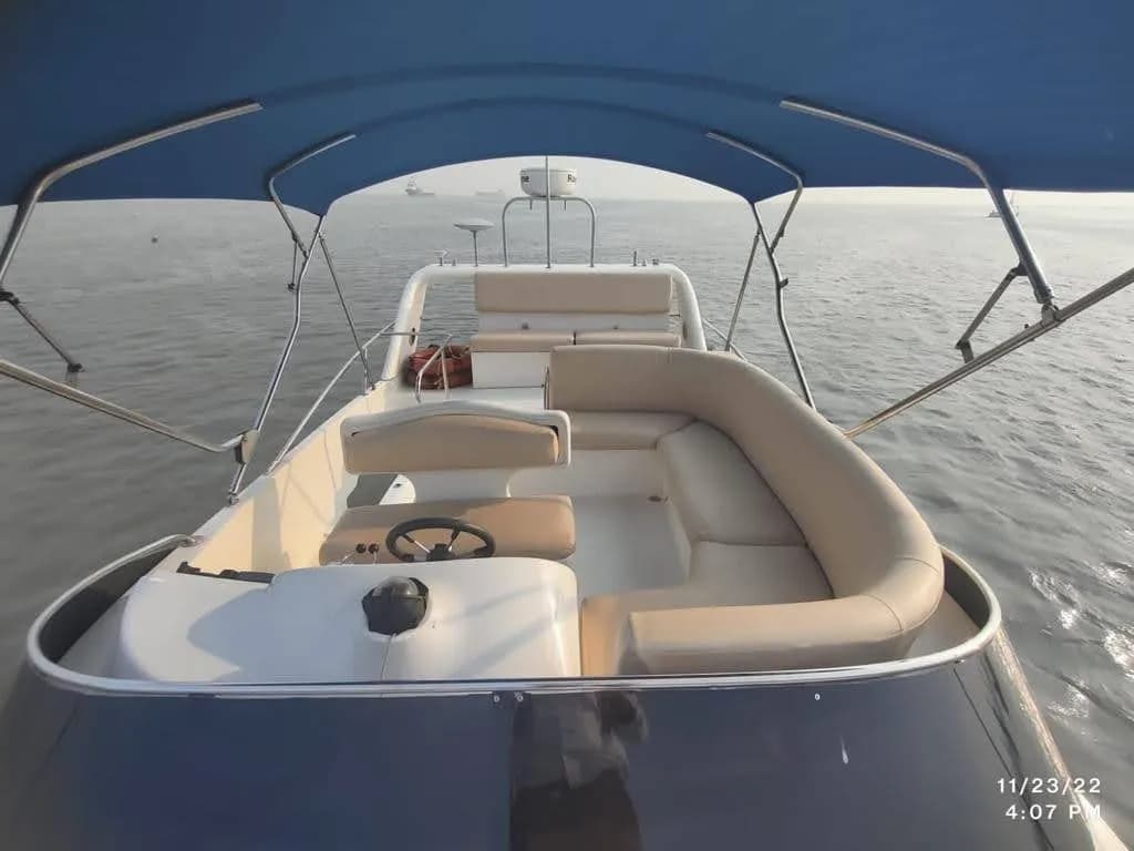 The flybridge helm and seating under a clear sky