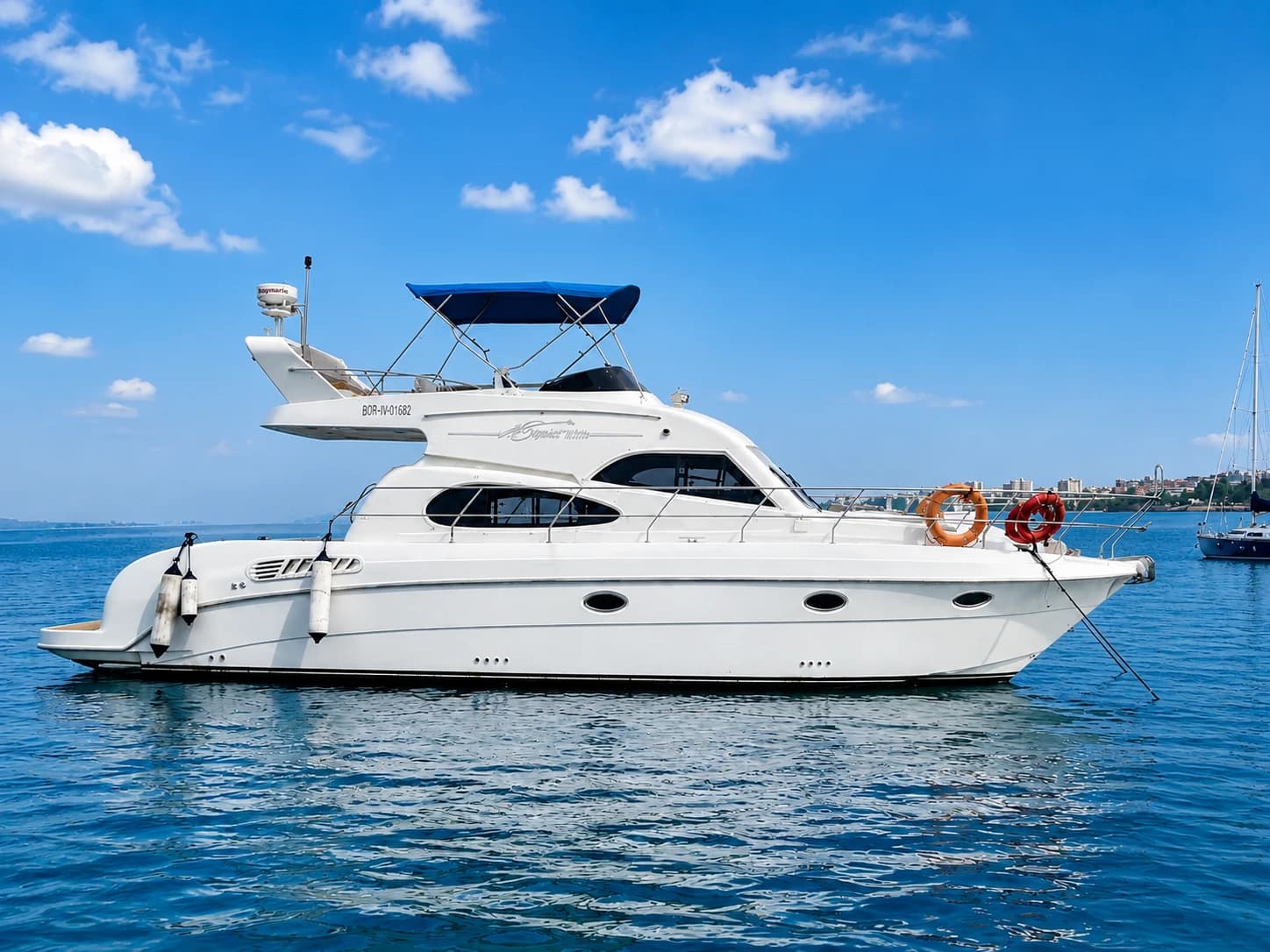 Vari 44's full side profile at anchor under a clear sky