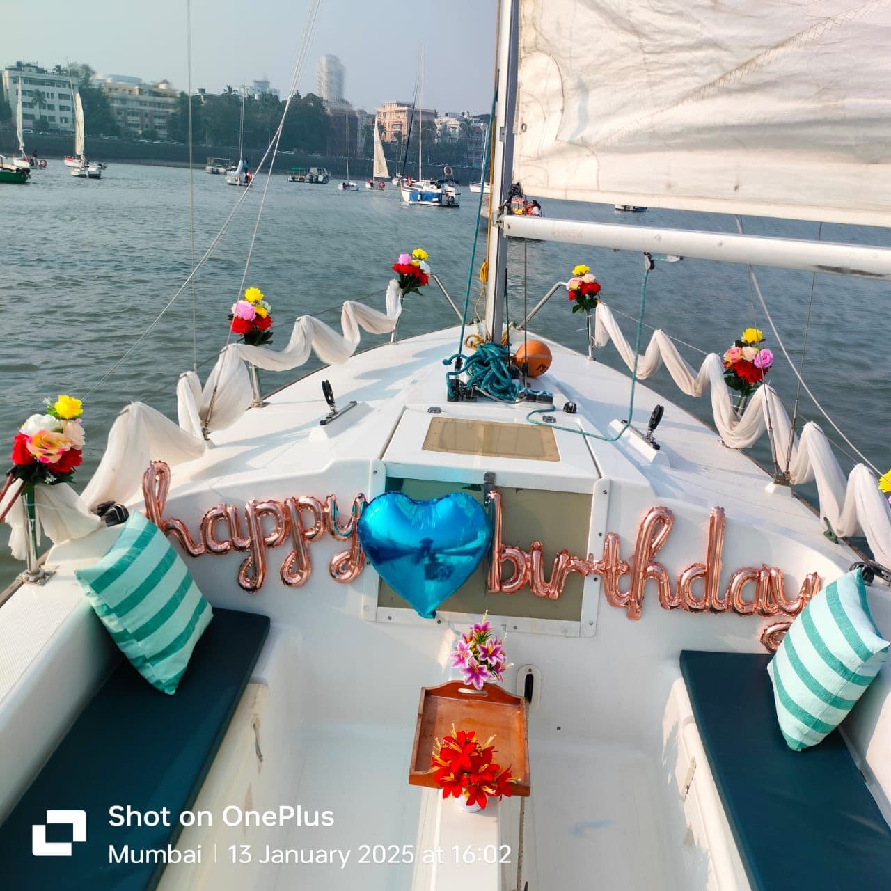 The sailboat Menaka under sail with guests aboard and the skipper at the helm
