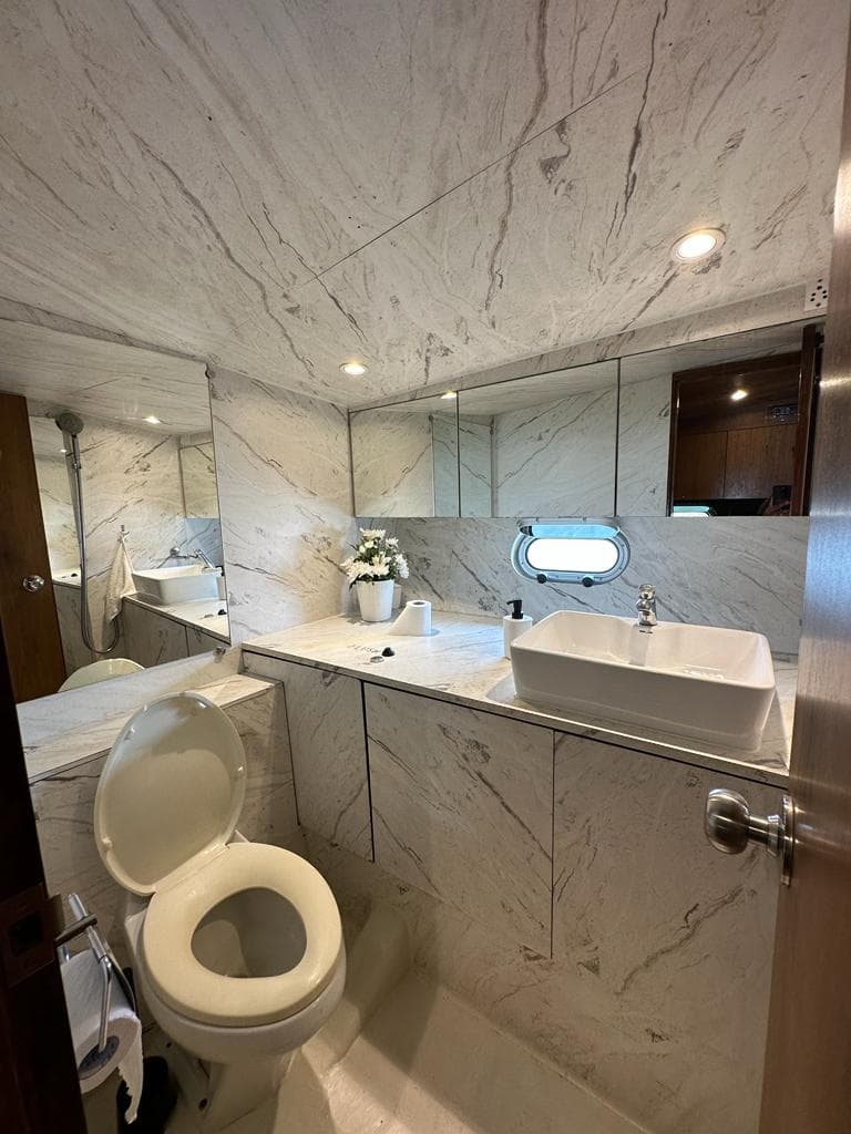 The ensuite marble bathroom with a rain shower and vanity