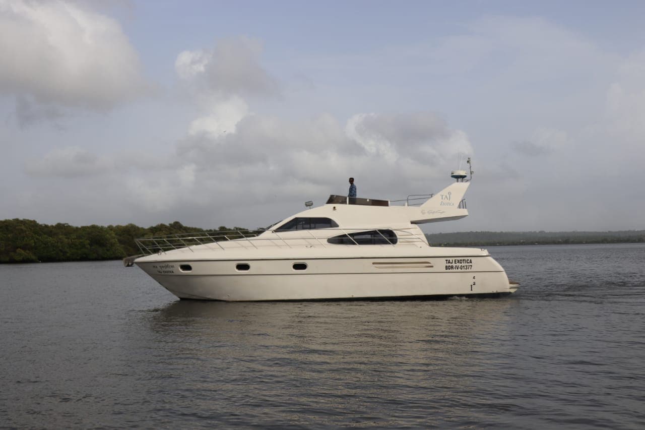 Taj Exotica's side profile with her nameplate, under way in Goa